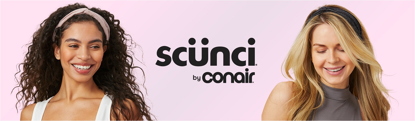 Two women wearing headbands smile against a light pink background next to the scünci by Conair logo.